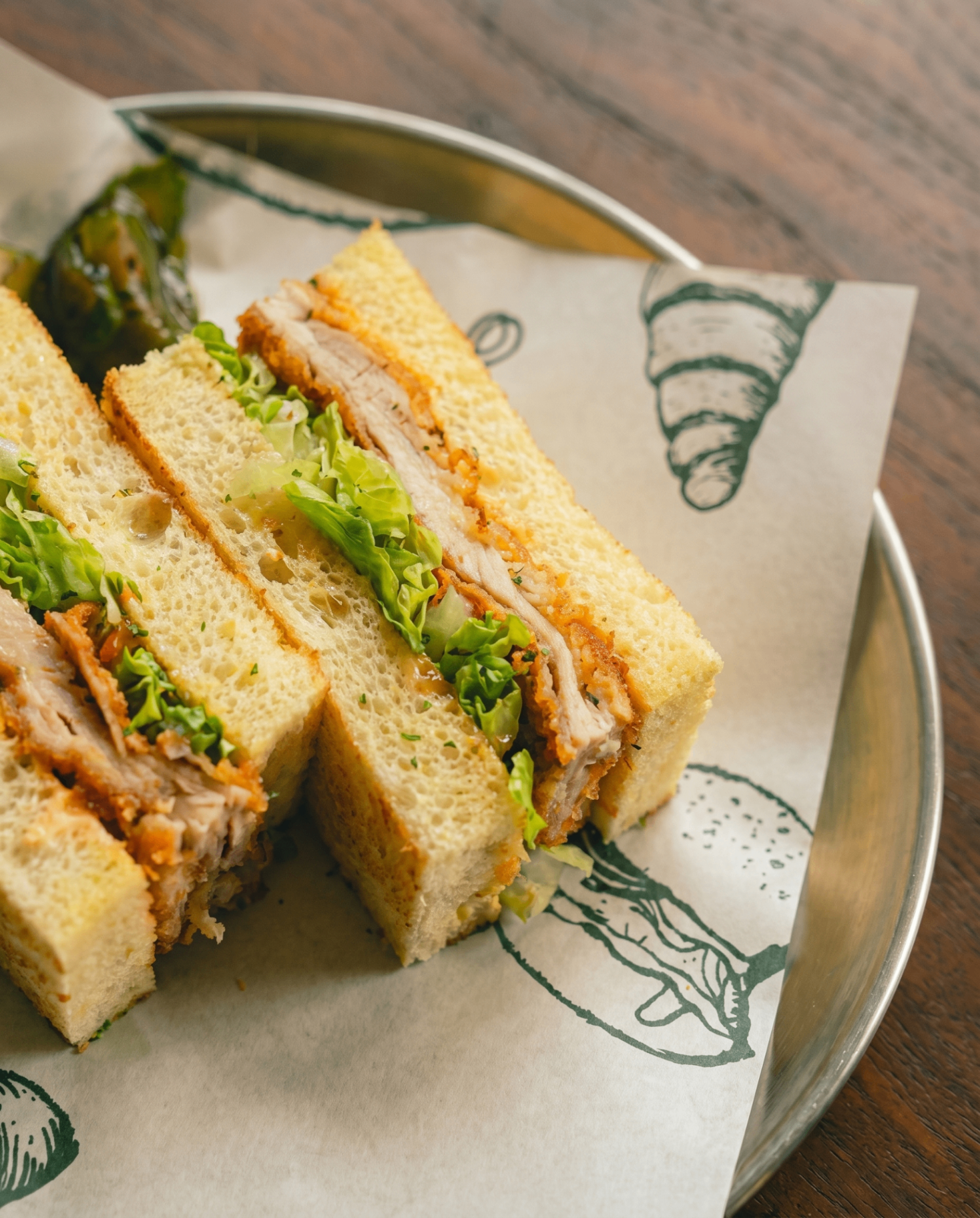 Chicken katsu sandwich with cabbage on milk bread at AVA Bistro Seseh