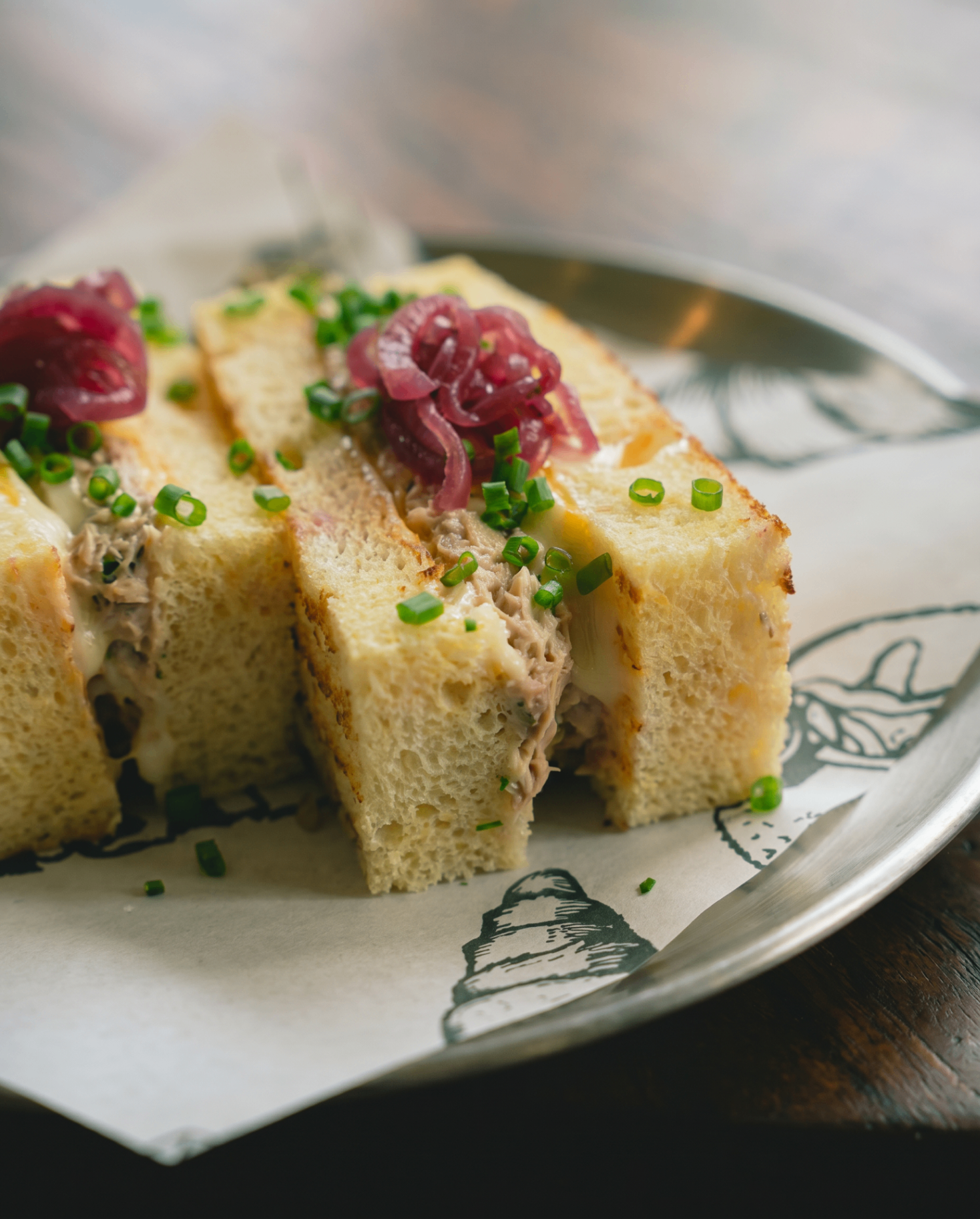 Tuna melt sandwich with pickled red onion and chives on a milk-bread loaf, AVA Bistro Seseh
