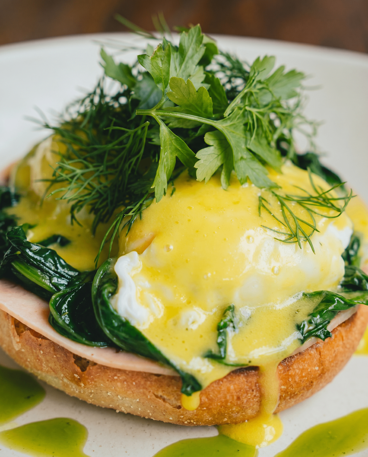Eggs Benedict with spinach, hollandaise and fresh herbs at AVA Bistro Seseh